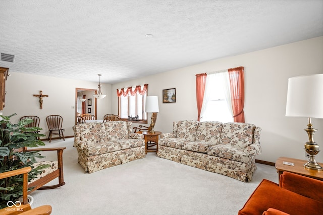 carpeted living room with a textured ceiling