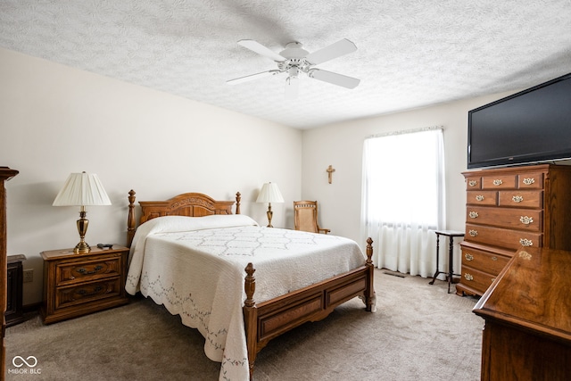 bedroom featuring ceiling fan, a textured ceiling, and carpet flooring