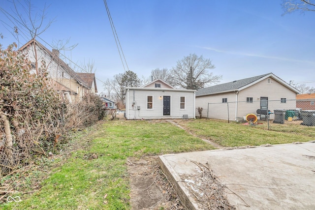 rear view of house with a lawn