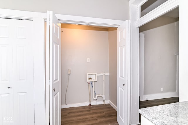 laundry area featuring laundry area, dark wood finished floors, and baseboards