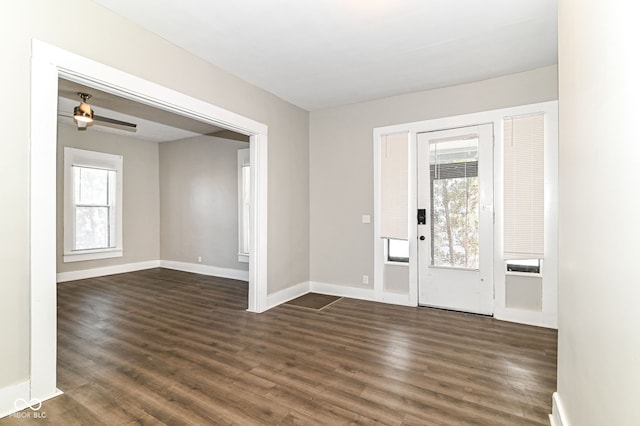 entryway with dark wood-style floors, ceiling fan, and baseboards