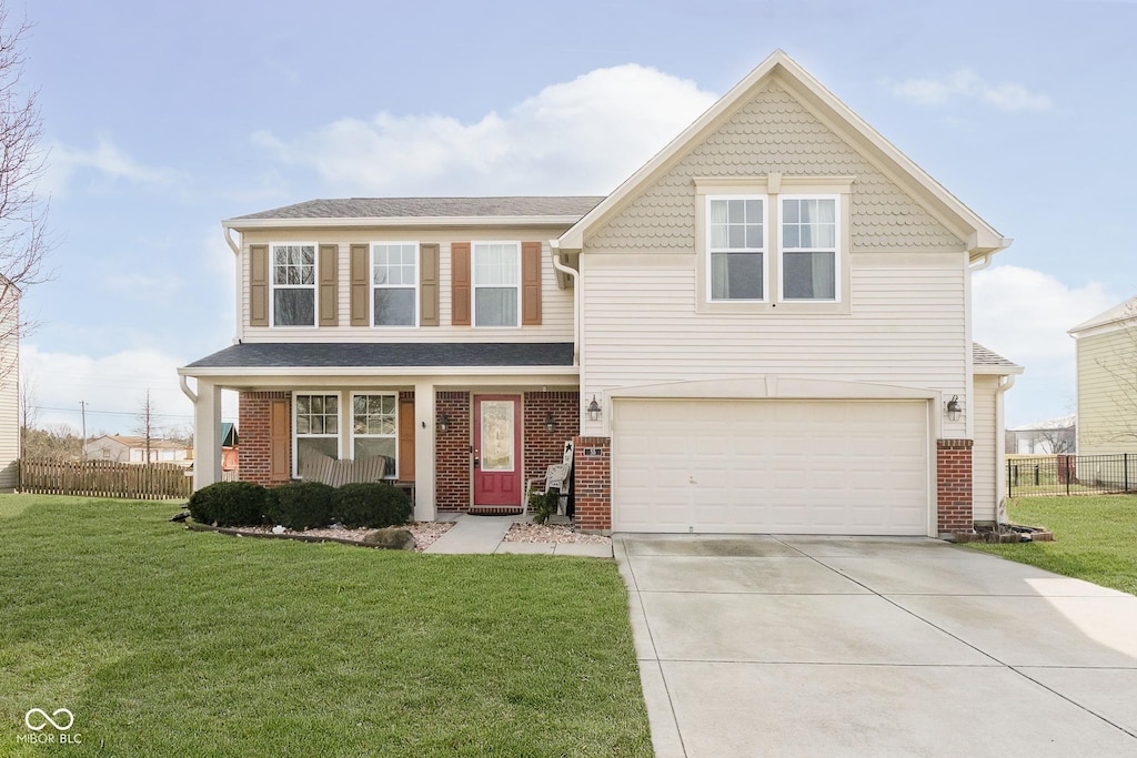 view of front property with a porch, a garage, and a front yard