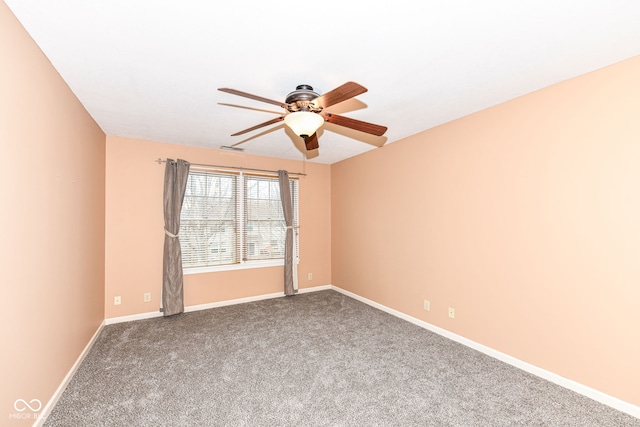 spare room featuring ceiling fan and carpet floors