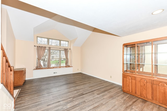 additional living space with lofted ceiling and dark wood-type flooring