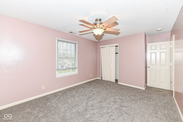 unfurnished bedroom with carpet floors, ceiling fan, and a closet