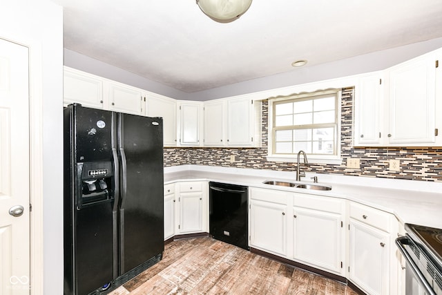 kitchen featuring white cabinetry, sink, decorative backsplash, and black appliances