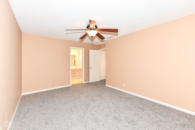 unfurnished bedroom with ceiling fan, ensuite bathroom, and carpet