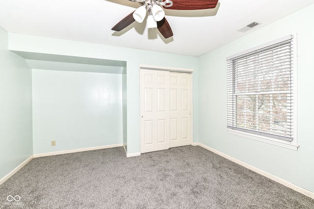 unfurnished bedroom with a closet, ceiling fan, and carpet