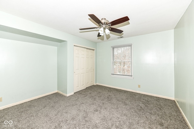 unfurnished bedroom featuring ceiling fan, carpet, and a closet