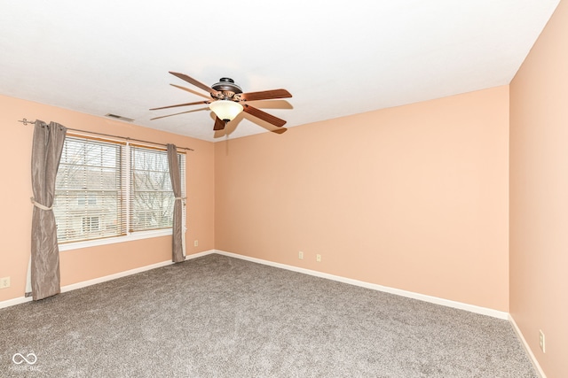 carpeted spare room featuring ceiling fan