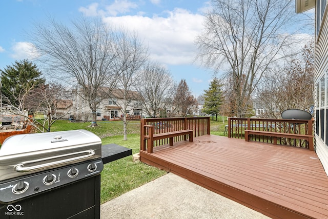 deck featuring area for grilling and a lawn