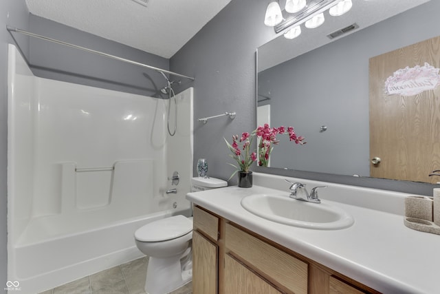 full bathroom featuring tile patterned floors, toilet, bathing tub / shower combination, a textured ceiling, and vanity