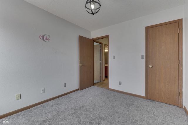 unfurnished bedroom with light carpet and a textured ceiling