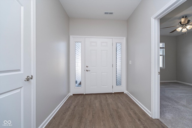 foyer with dark hardwood / wood-style floors and ceiling fan