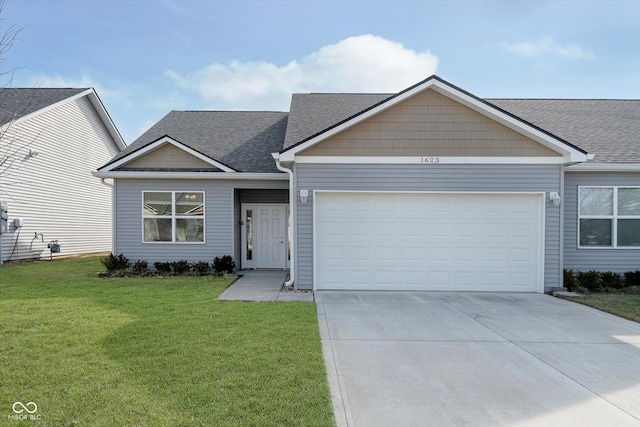 view of front of property featuring a garage and a front lawn