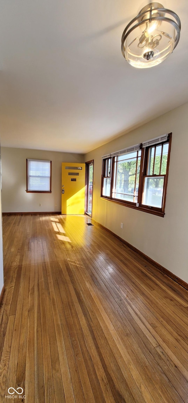 unfurnished living room with hardwood / wood-style flooring