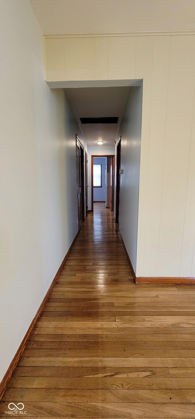 hall with hardwood / wood-style floors