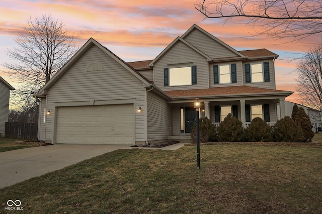 view of front facade featuring a garage and a yard