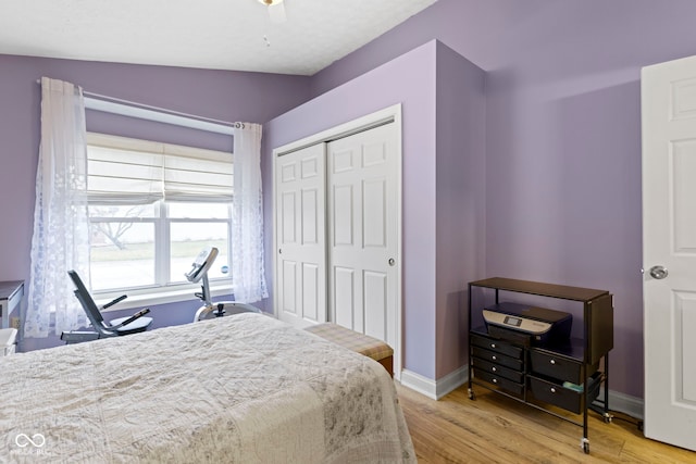 bedroom with light hardwood / wood-style floors and a closet