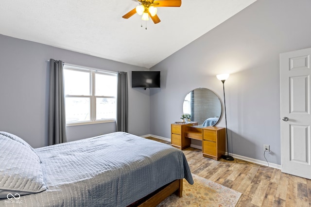 bedroom featuring vaulted ceiling, ceiling fan, and light hardwood / wood-style flooring