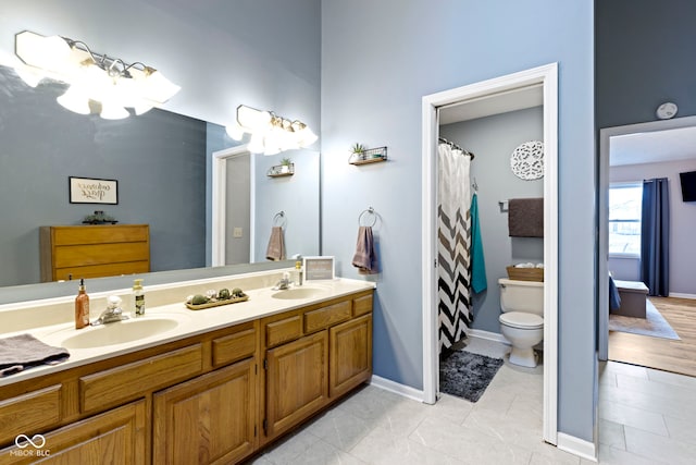 bathroom featuring vanity, tile patterned floors, and toilet