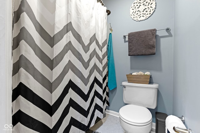 bathroom with a shower with curtain and toilet