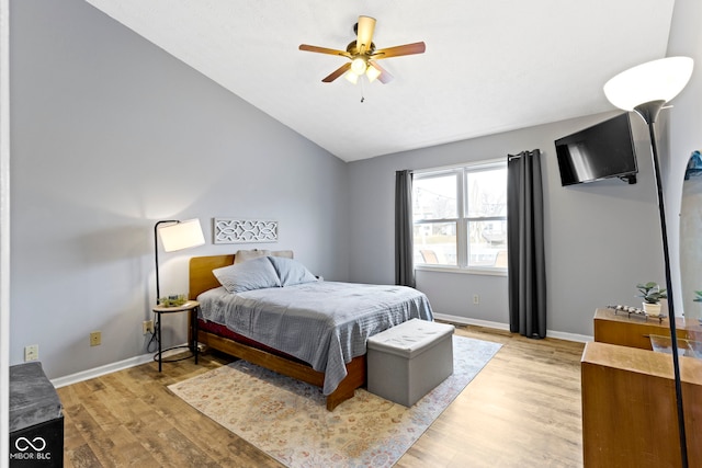 bedroom featuring vaulted ceiling, light hardwood / wood-style floors, and ceiling fan