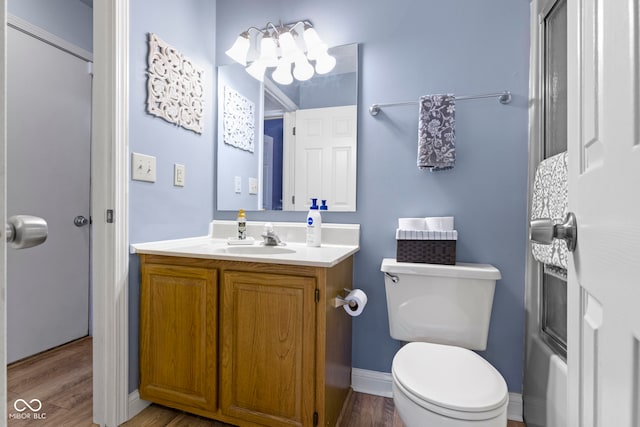 full bathroom with shower / bath combination with glass door, vanity, toilet, and hardwood / wood-style flooring