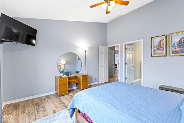 bedroom featuring ceiling fan, vaulted ceiling, and light wood-type flooring