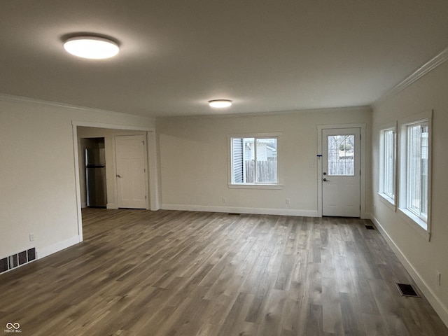 interior space with dark wood-type flooring and ornamental molding