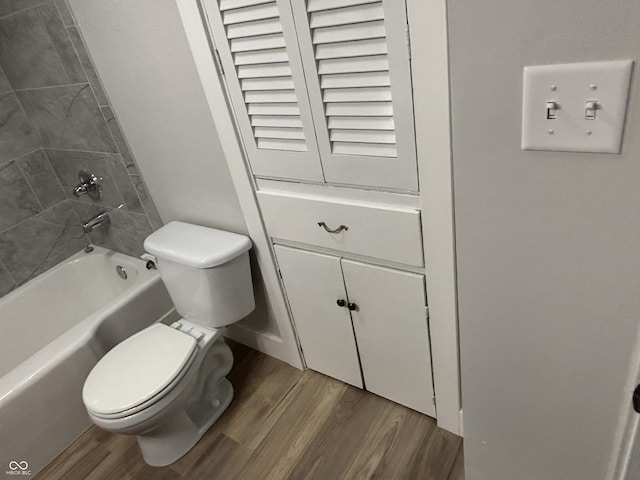 bathroom featuring hardwood / wood-style flooring and toilet