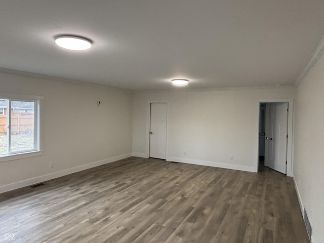 spare room with crown molding and hardwood / wood-style floors