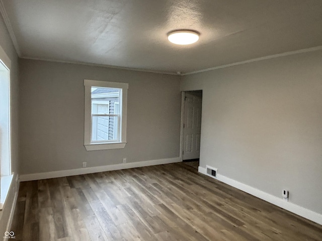 unfurnished room with ornamental molding, hardwood / wood-style floors, and a textured ceiling