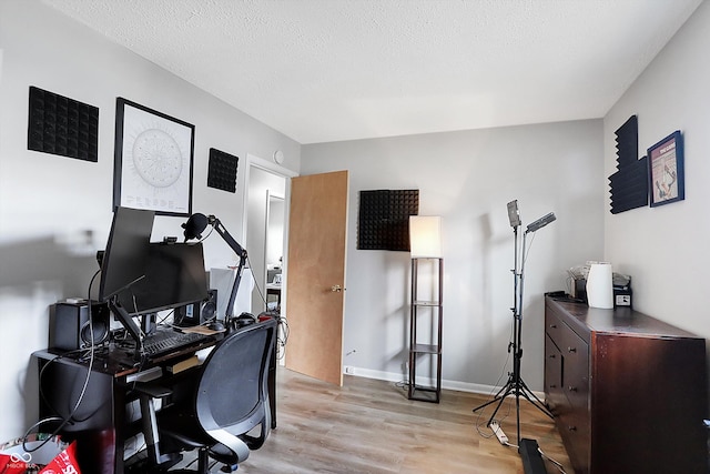 office featuring light hardwood / wood-style flooring and a textured ceiling