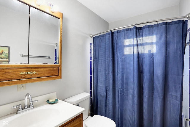 bathroom with vanity, toilet, and curtained shower