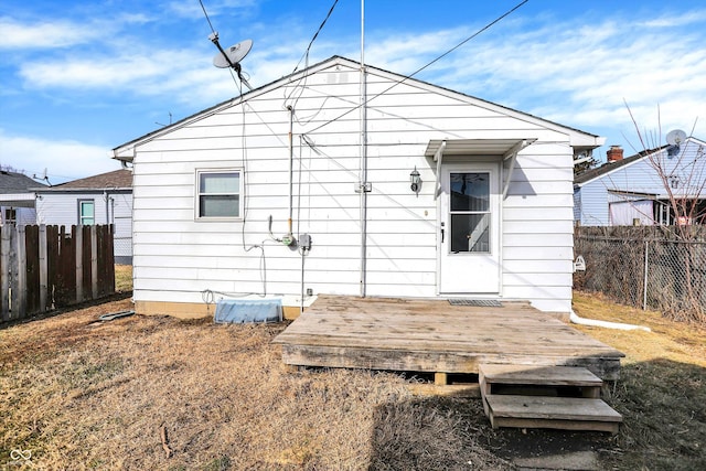 back of house with a deck