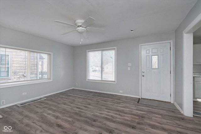 entrance foyer with dark wood finished floors, visible vents, and baseboards