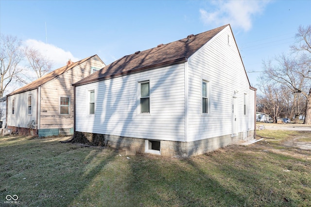 view of side of property with a lawn