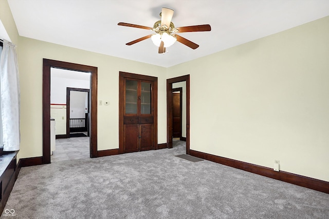 unfurnished bedroom with carpet flooring and ceiling fan