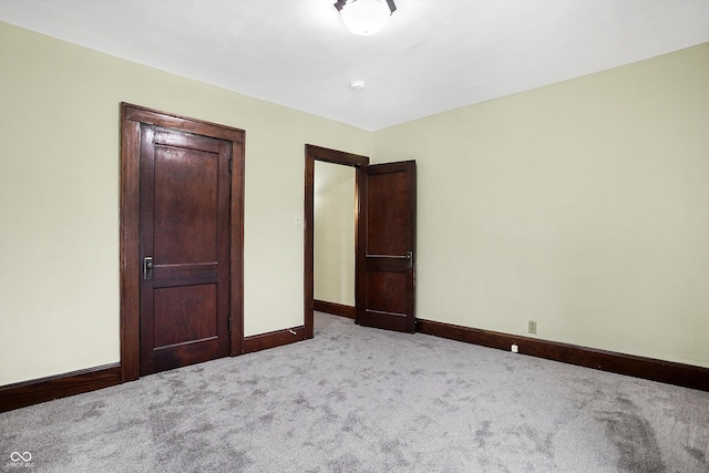 unfurnished bedroom with light colored carpet