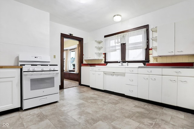 kitchen featuring white cabinetry, white gas range, backsplash, and sink