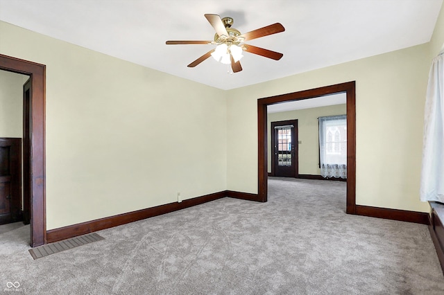 carpeted empty room featuring ceiling fan