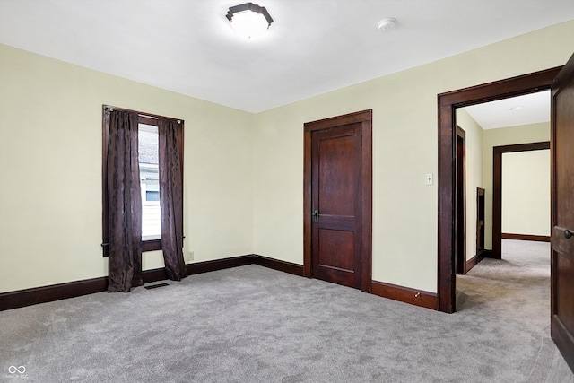 spare room featuring light colored carpet