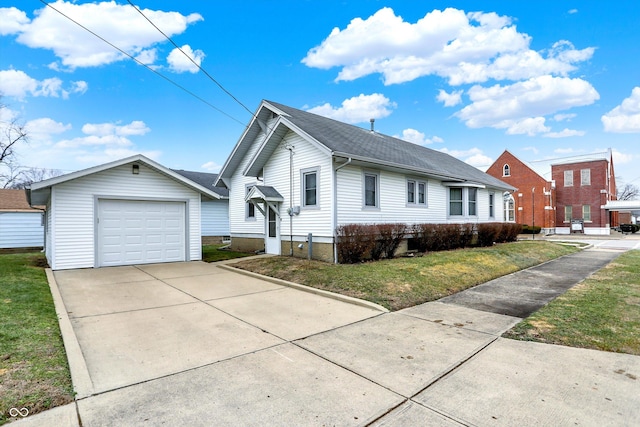 ranch-style home featuring an outbuilding, a garage, and a front lawn