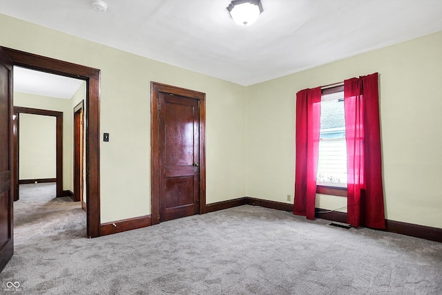 unfurnished bedroom with light colored carpet