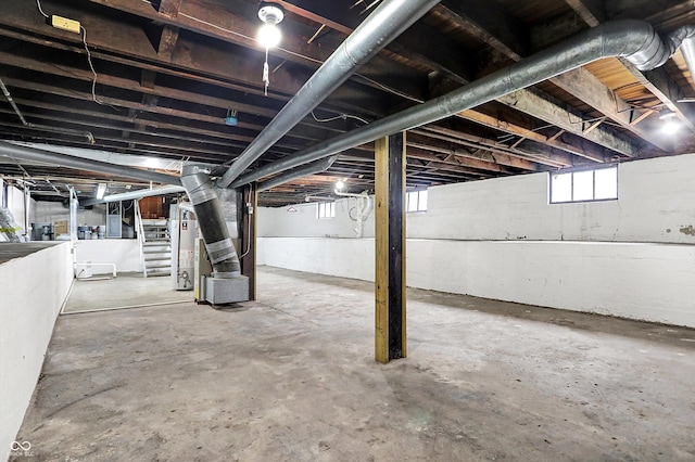 basement featuring heating unit and water heater