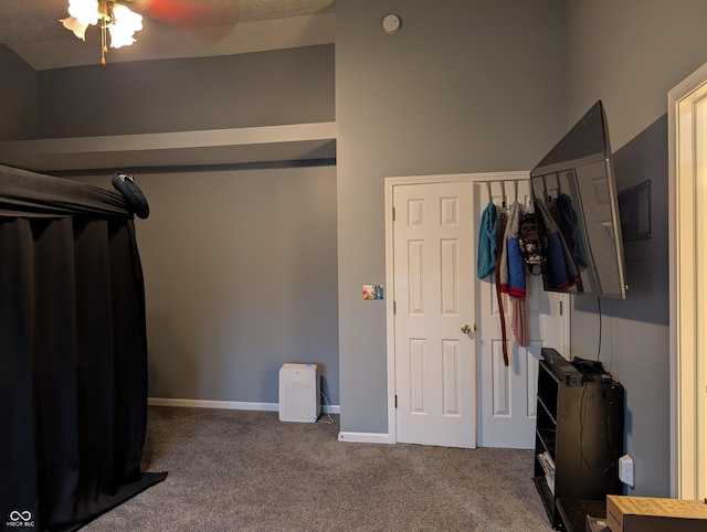 interior space with ceiling fan and carpet