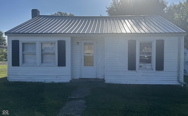 view of front of home featuring a chimney and metal roof