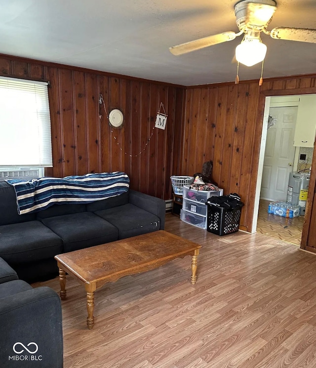 210 N Wayne St, Van Buren, IN 46991 - living room with wood finished floors, ceiling fan, wood walls, and baseboard heating