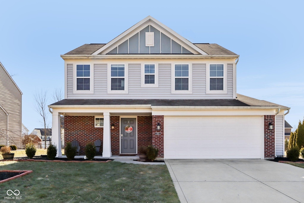 front facade featuring a garage and a front lawn